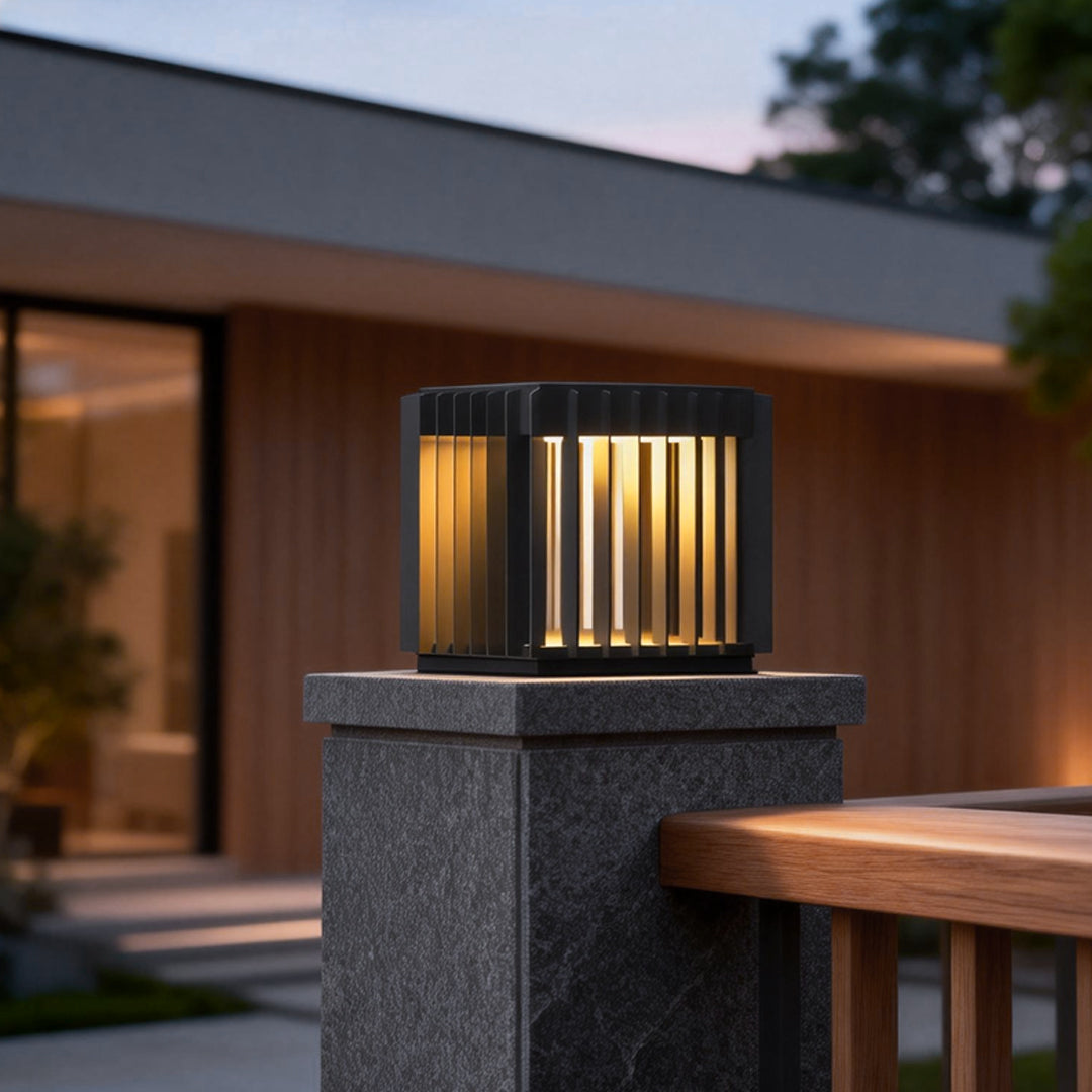 Exterior pillar lights illuminating a modern house entrance with wooden and stone accents at dusk.