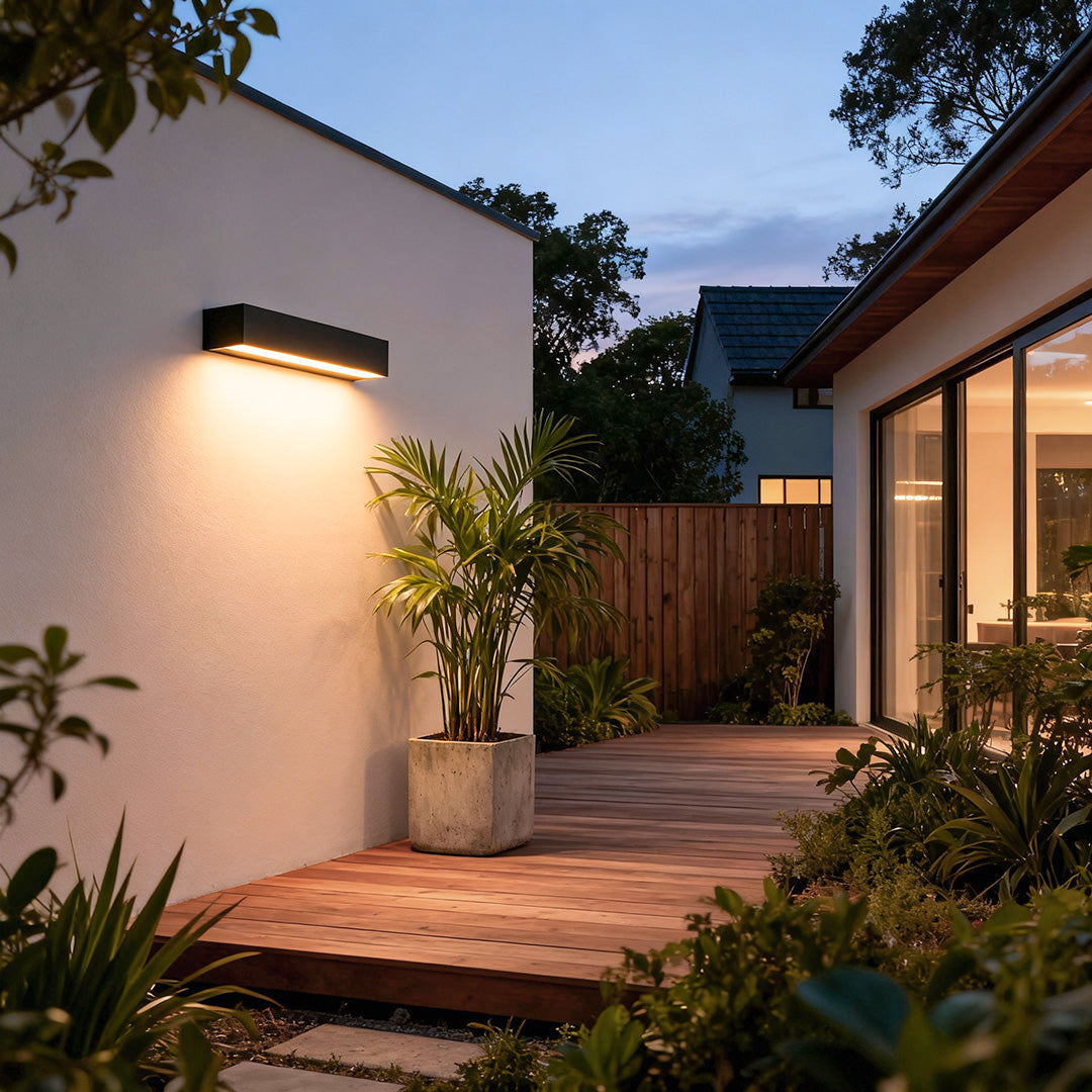 Modern exterior porch light fixtures with slim rectangular design mounted in the garden.