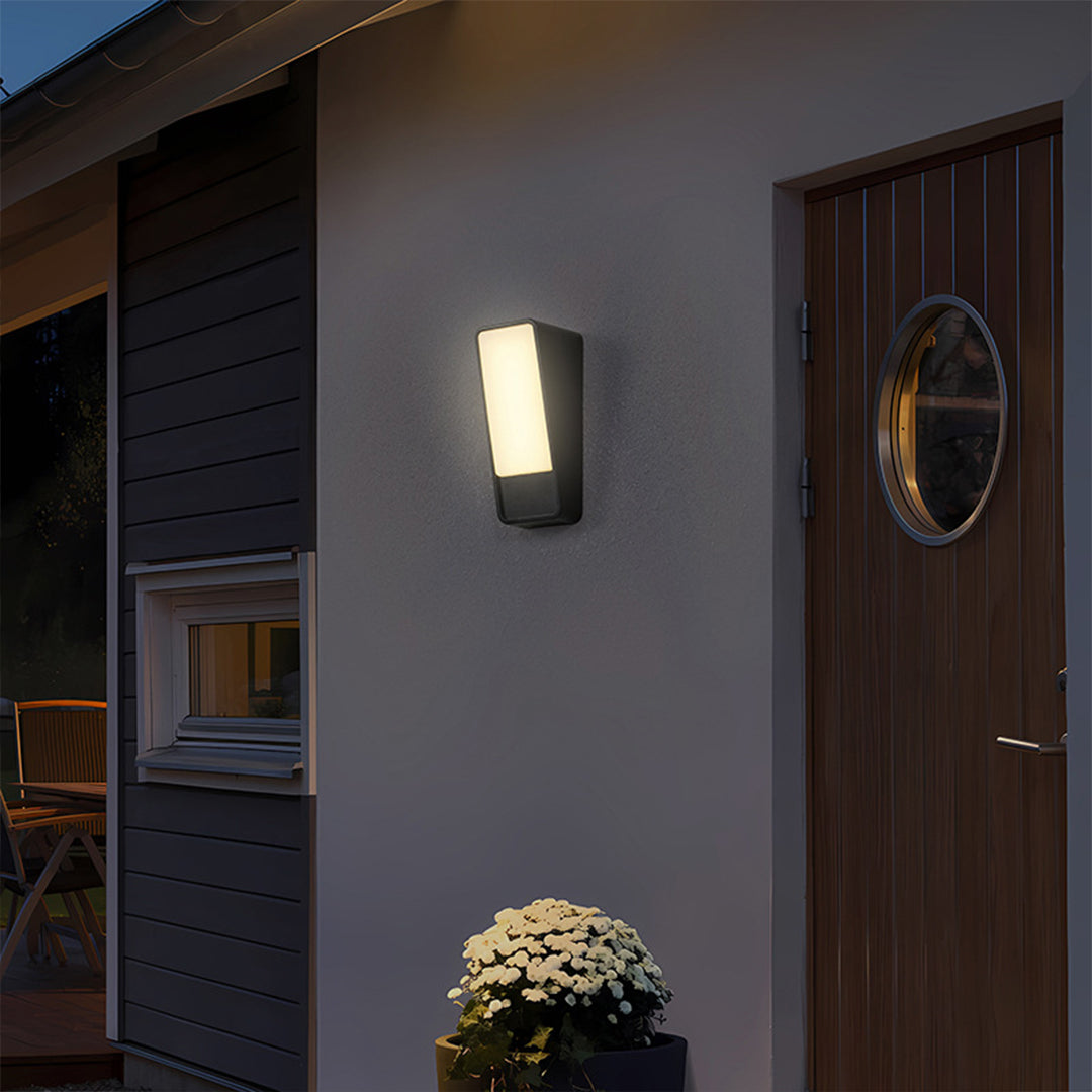 Exterior wall lights providing welcoming illumination on modern home entrance at evening
