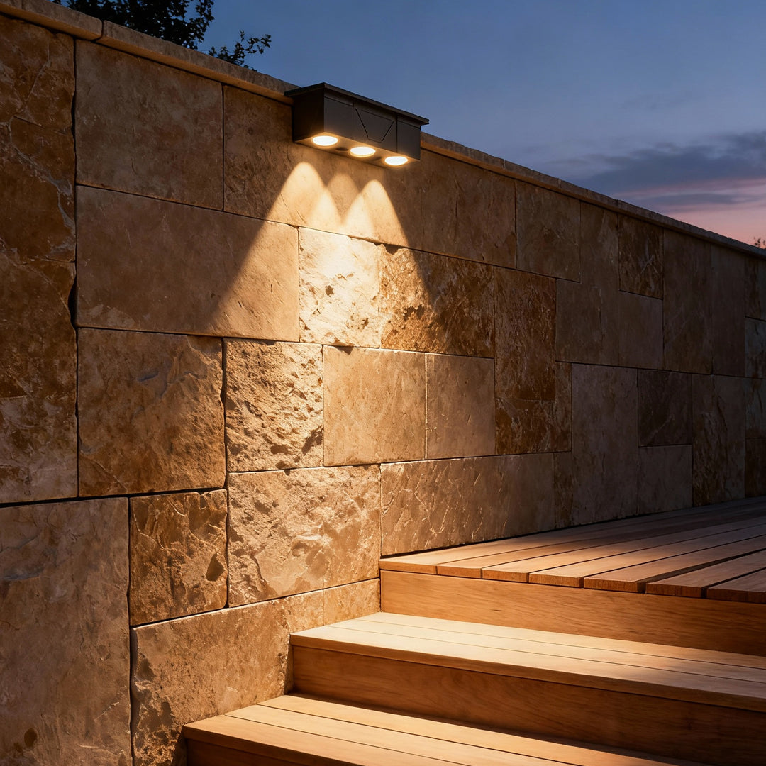 Warm exterior wall wash lighting highlighting architectural stone textures along outdoor steps.