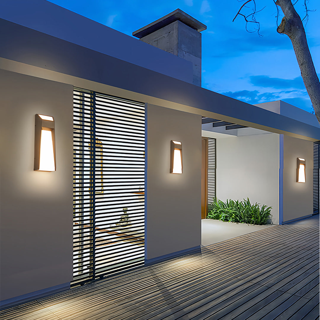 Extra large outdoor wall lights creating dramatic evening illumination on contemporary white facade with geometric patterns