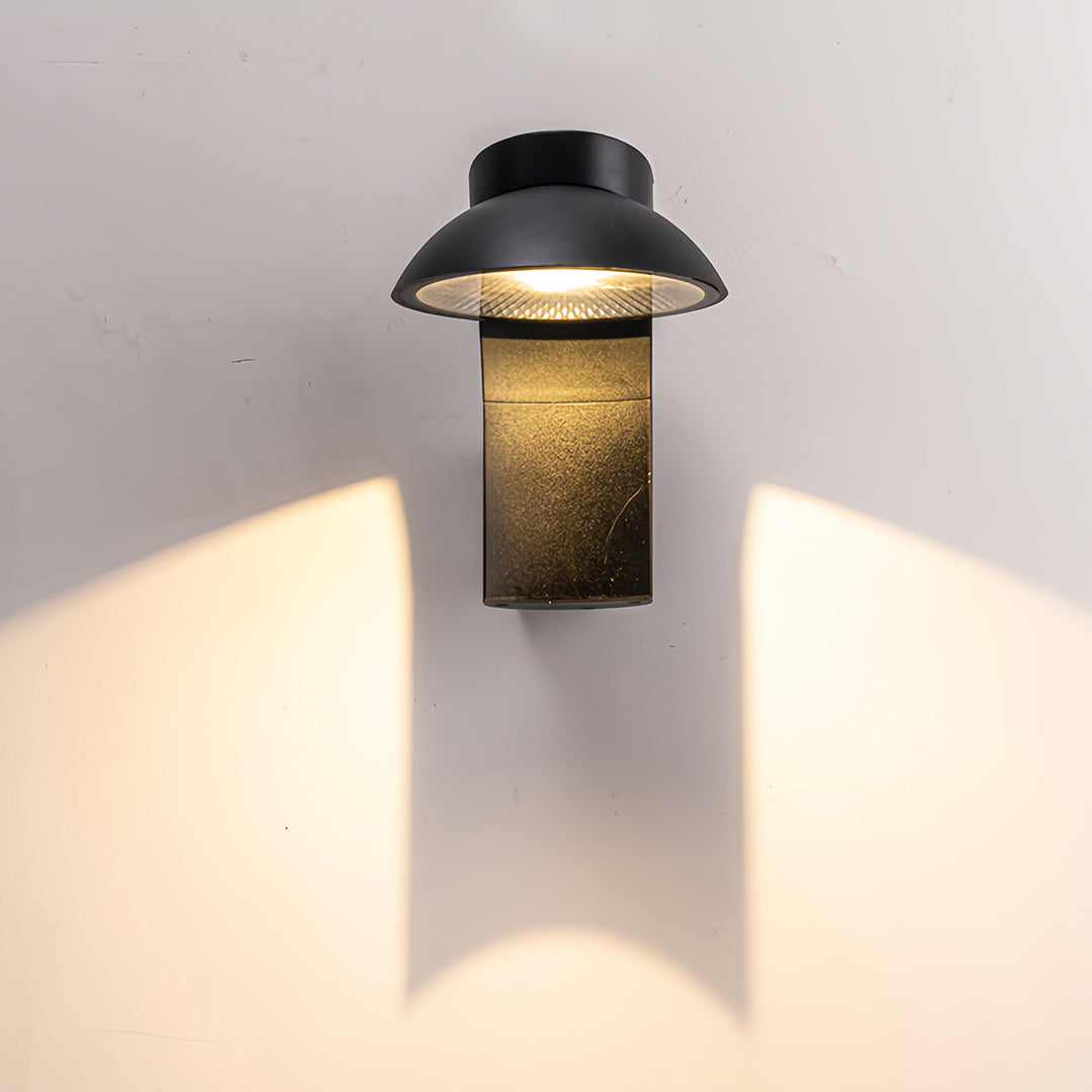 Extra large outdoor wall light in rustic finish casting symmetrical light patterns.