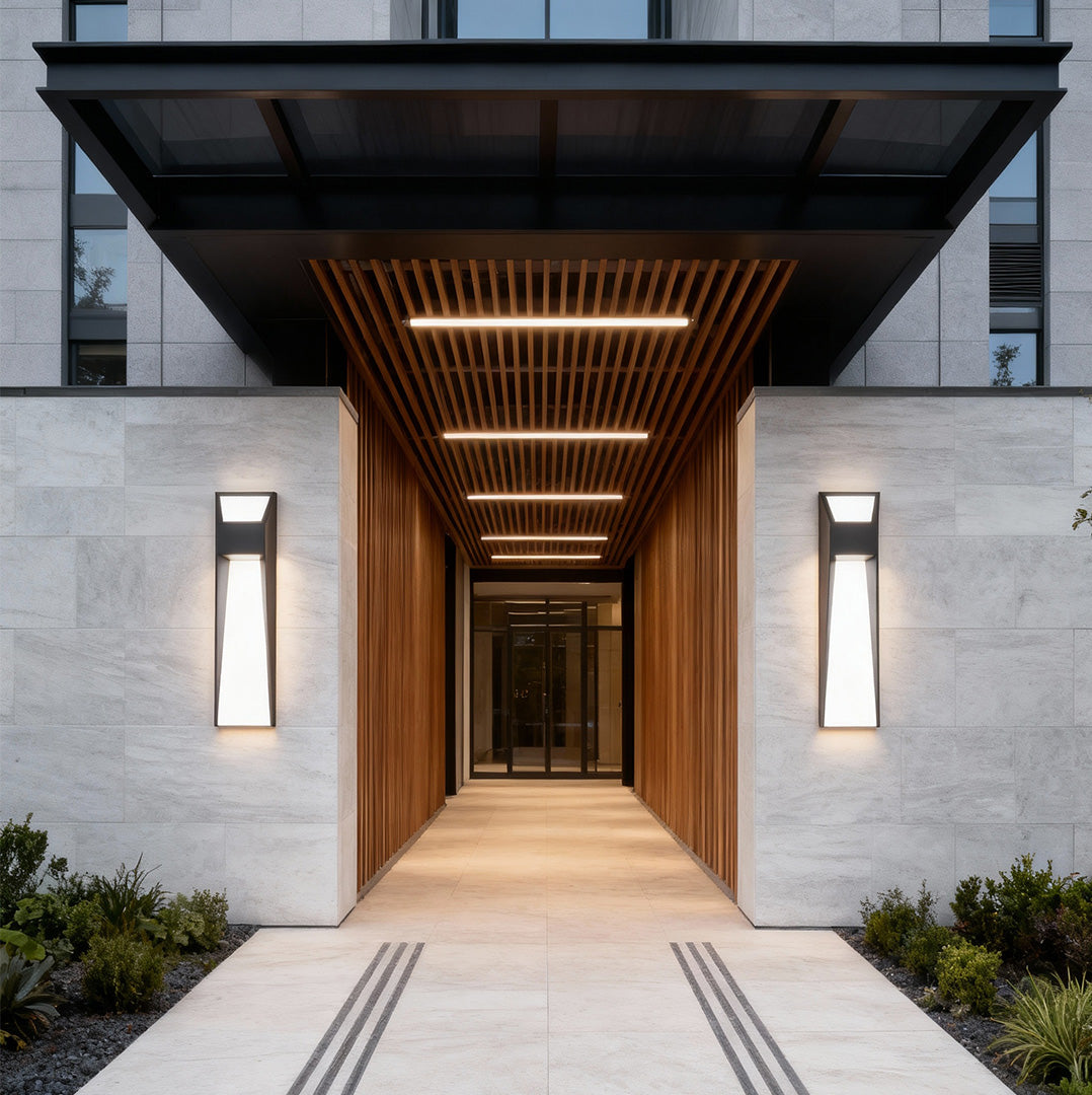Extra large outdoor wall lights flanking covered walkway in contemporary architecture with slatted ceiling design