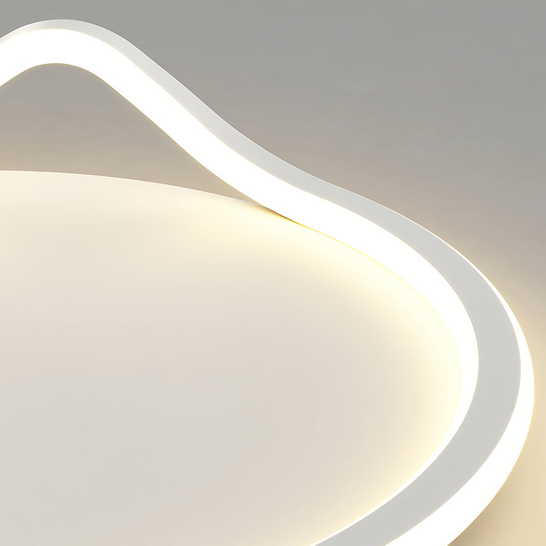 Extreme close-up of the smooth, curved white LED element of the geometric flush mount light, showcasing the soft illumination.