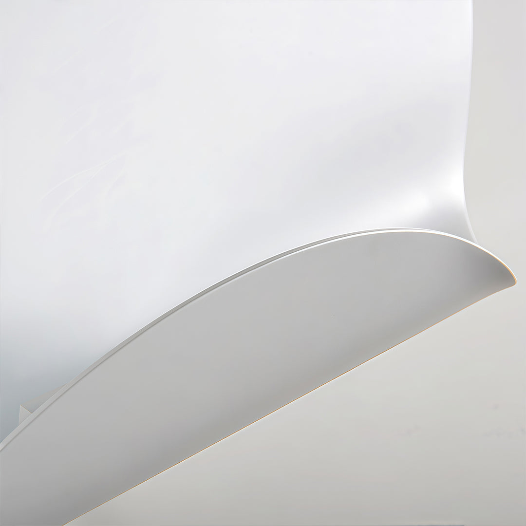 Extreme close-up of the smooth curve and thin profile of the modern white wall lights fixture.