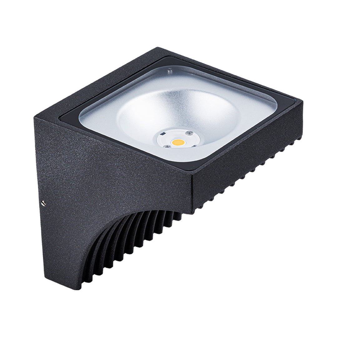 Traditional brass wall lantern with frosted glass shade mounted on stone exterior wall