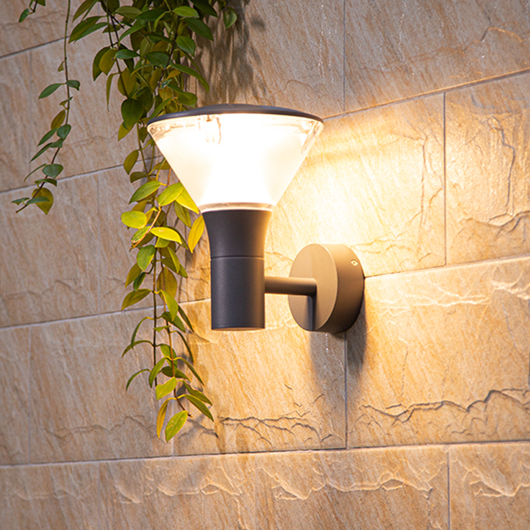 Textured stone wall featuring warm-toned rectangular wall sconce creating atmospheric lighting effects