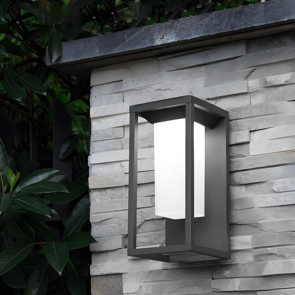Modern outdoor lighting fixture installed on white wooden siding creating atmospheric evening illumination
