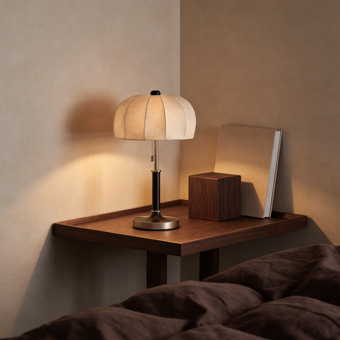 Fabric table lamp with a close-up of its elegant fabric shade on a bedside table.