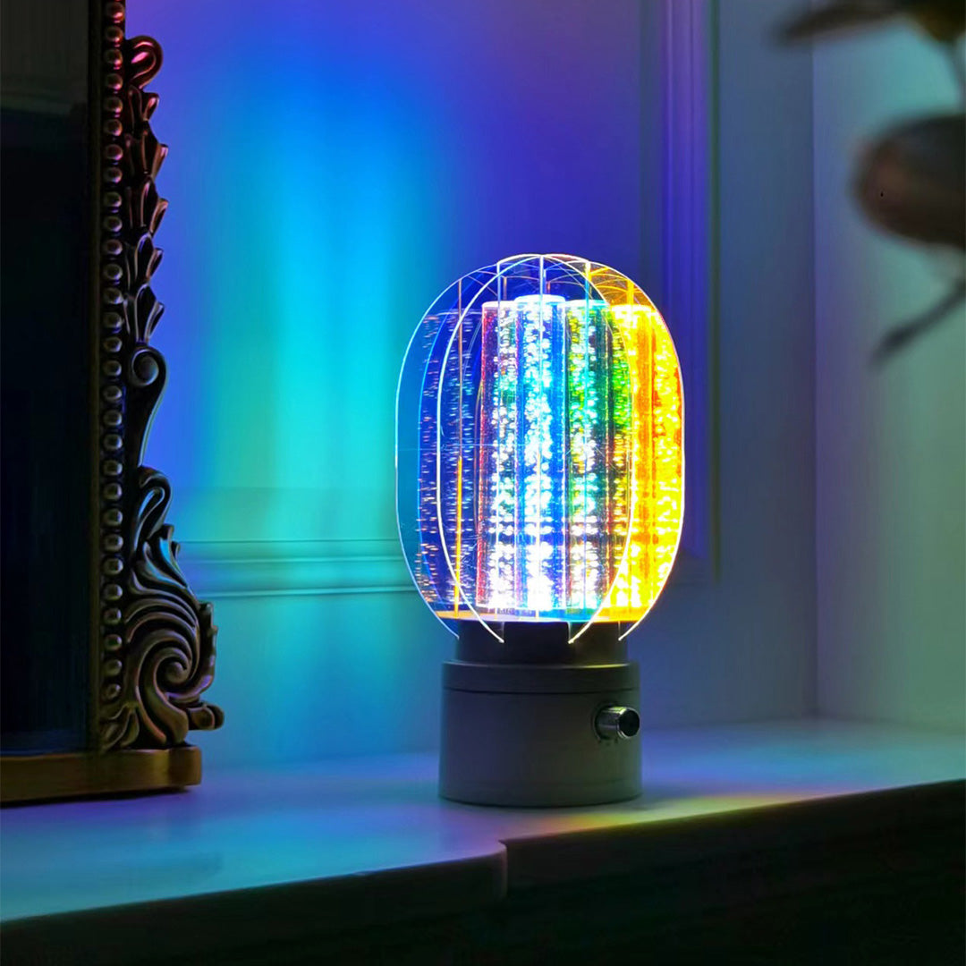Close-up of the colourful table lamp's faceted crystal-like surface, illuminating the rich blues, greens, and yellows of the light.