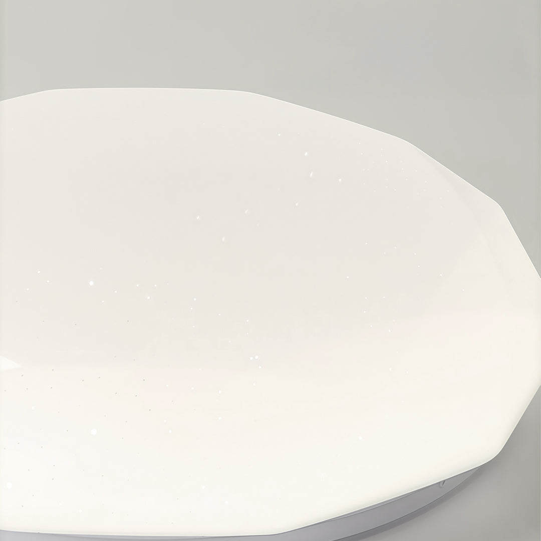 Detailed side view of geometric flush mount ceiling light with faceted diffuser and smooth edges.