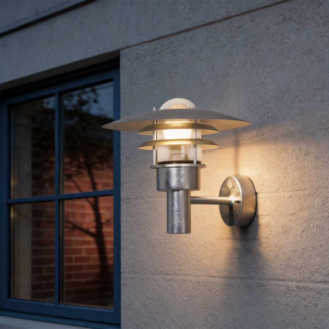 Farmhouse outdoor sconce with a classic black design, providing warm illumination near a porch.