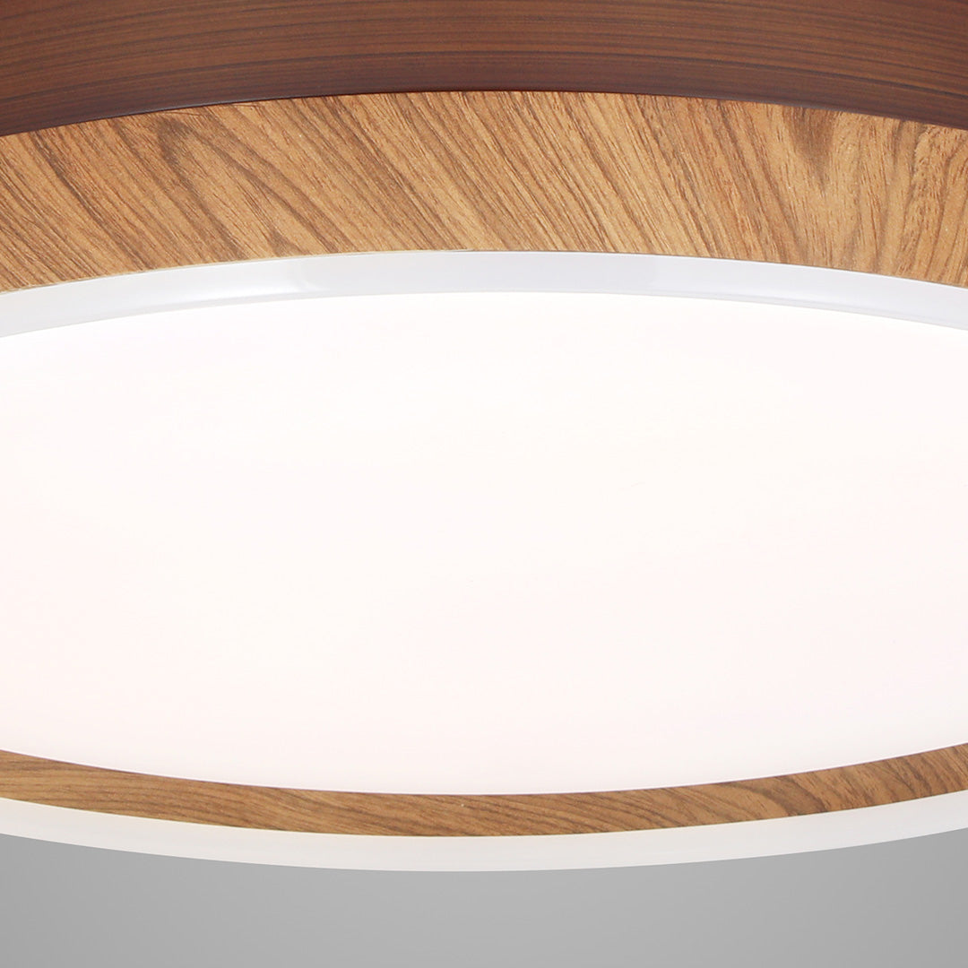 Close-up of the faux wood trim and diffused LED light on the ceiling fan with 4 lights 