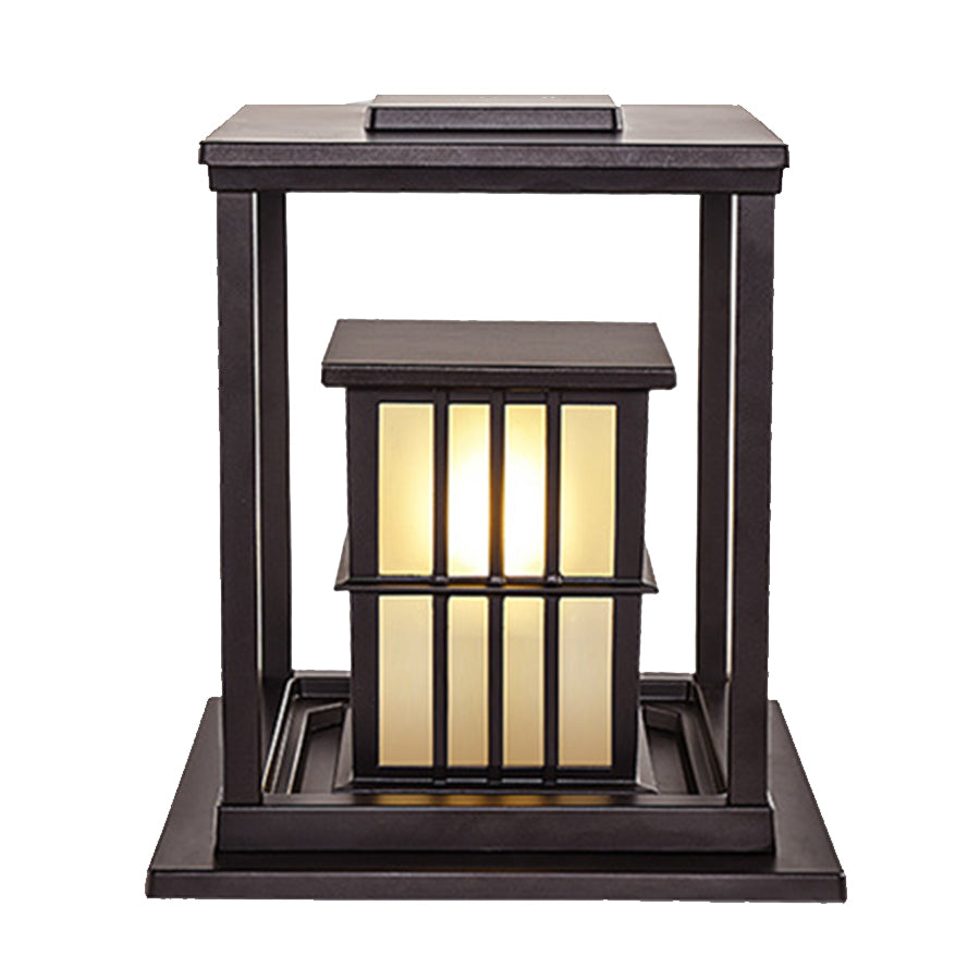 Two elegant post cap lights with vertical bar design illuminating concrete pillars at evening