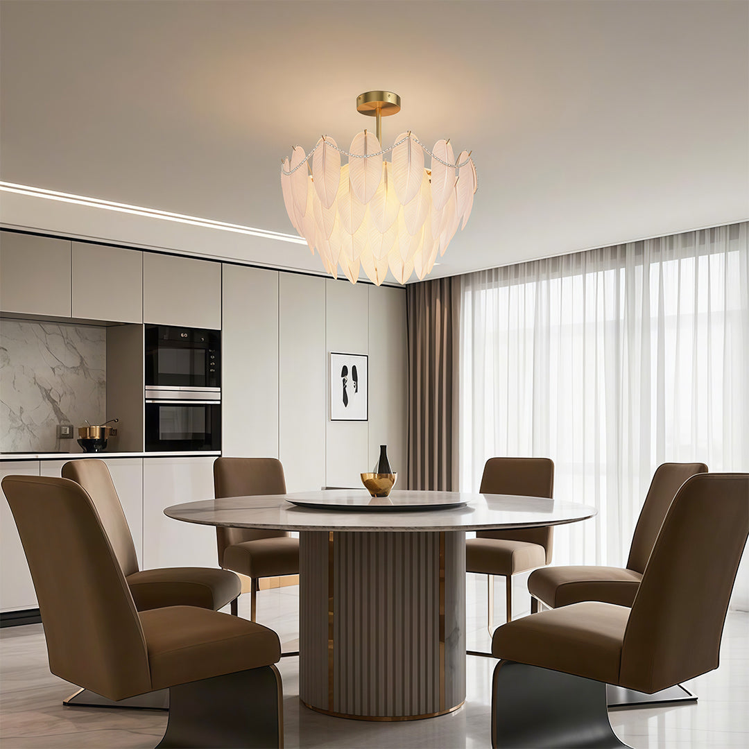 Modern luxury chandeliers above elegant dining table with velvet chairs and wine storage