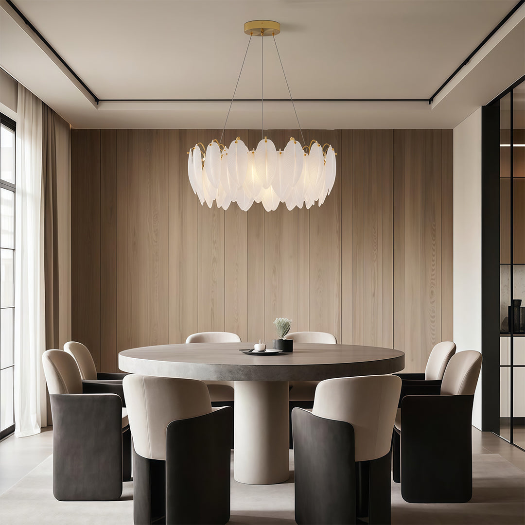 Feather chandeliers creating warm ambiance in living room with arched windows