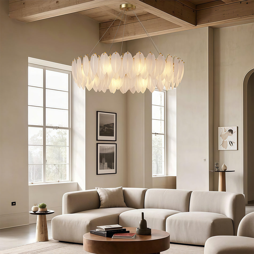 Feather chandeliers illuminating spacious living area with floor-to-ceiling windows