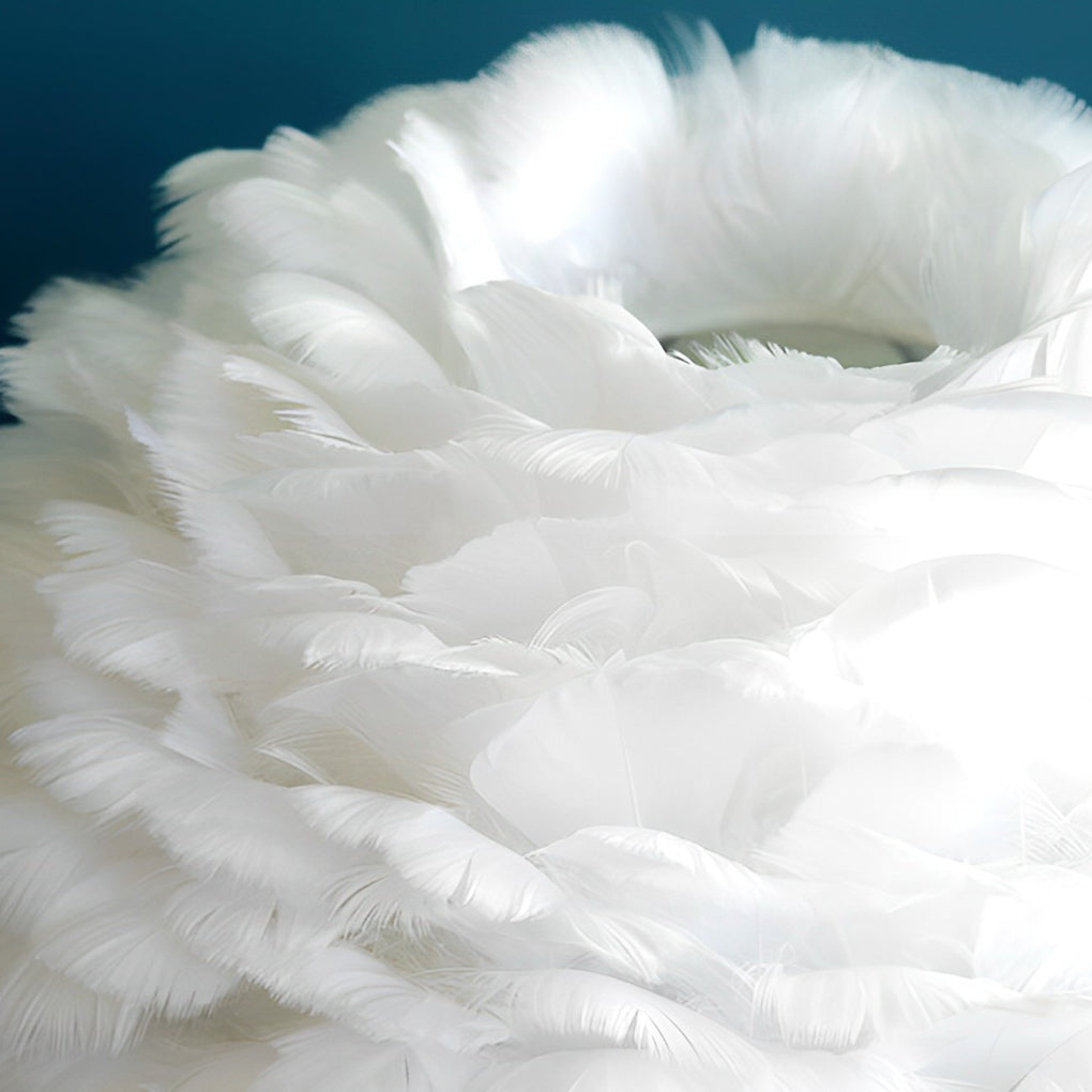 Close-up of layered white feathers used in a feather lamp shade.