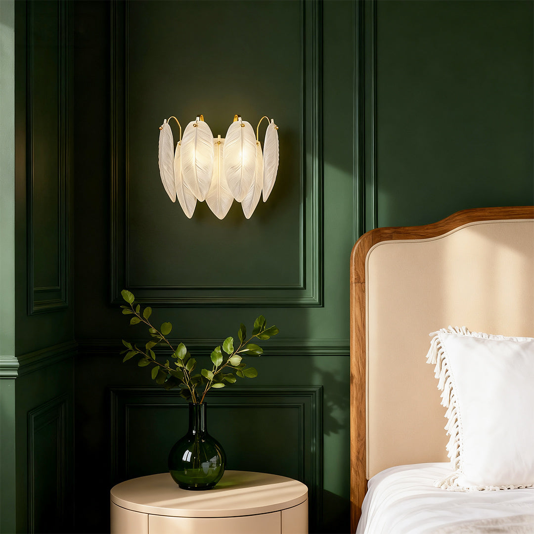 Feather wall light illuminating luxurious bedroom with deep green paneled walls and elegant decor