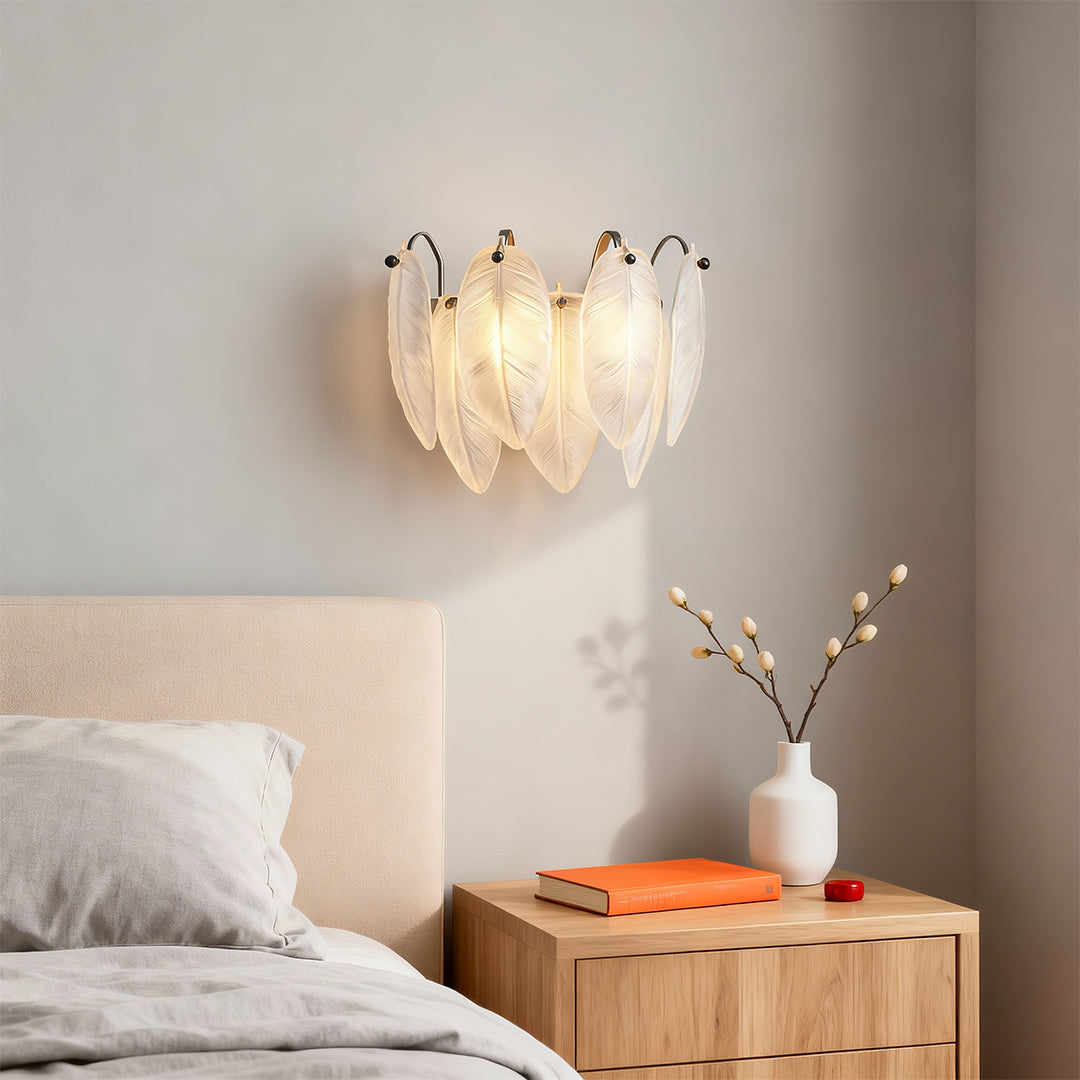 Feather wall light providing warm illumination in serene bedroom with wooden nightstand