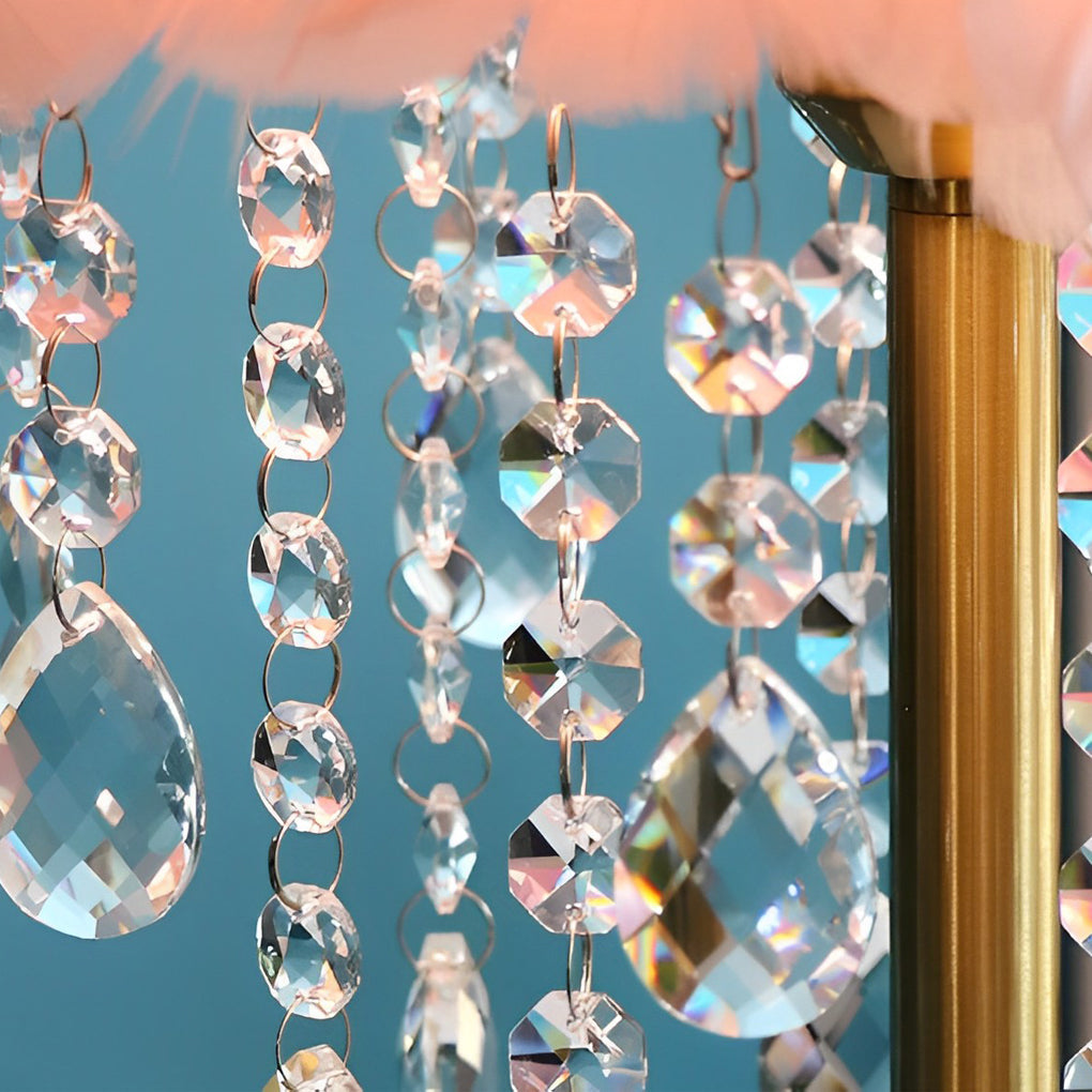Close-up detail of crystal bead strands hanging from a feather table lamp.