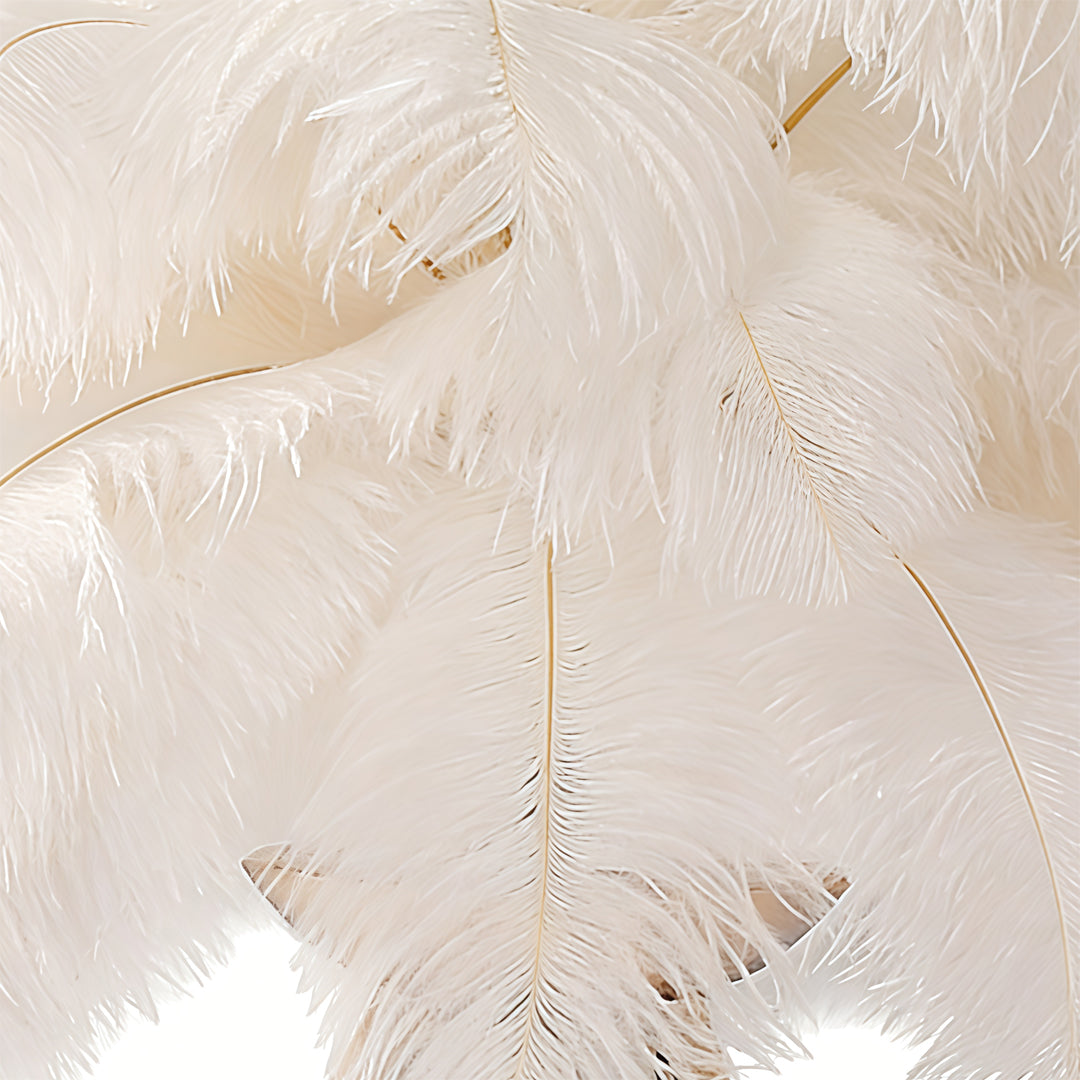 Feather table lamp with a white feather design, placed on a wooden surface.