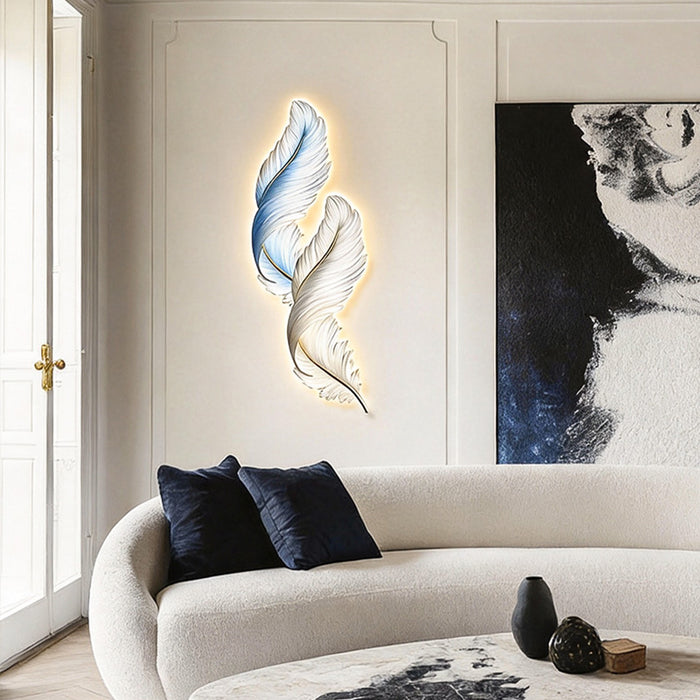 Feather wall decor light mounted above a sofa, adding artistic glow and soft ambient lighting to a modern living room.