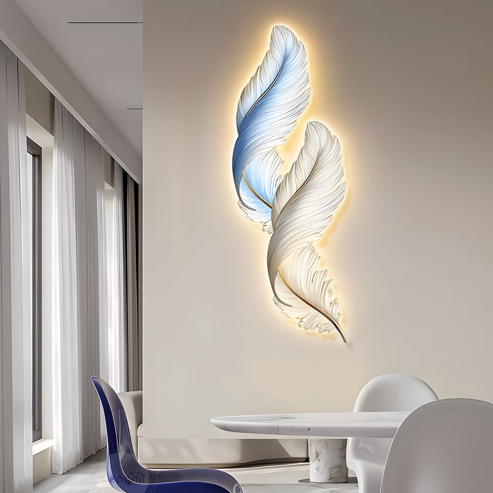 Tall feather wall decor light mounted beside windows, creating an elegant vertical accent with warm glow.