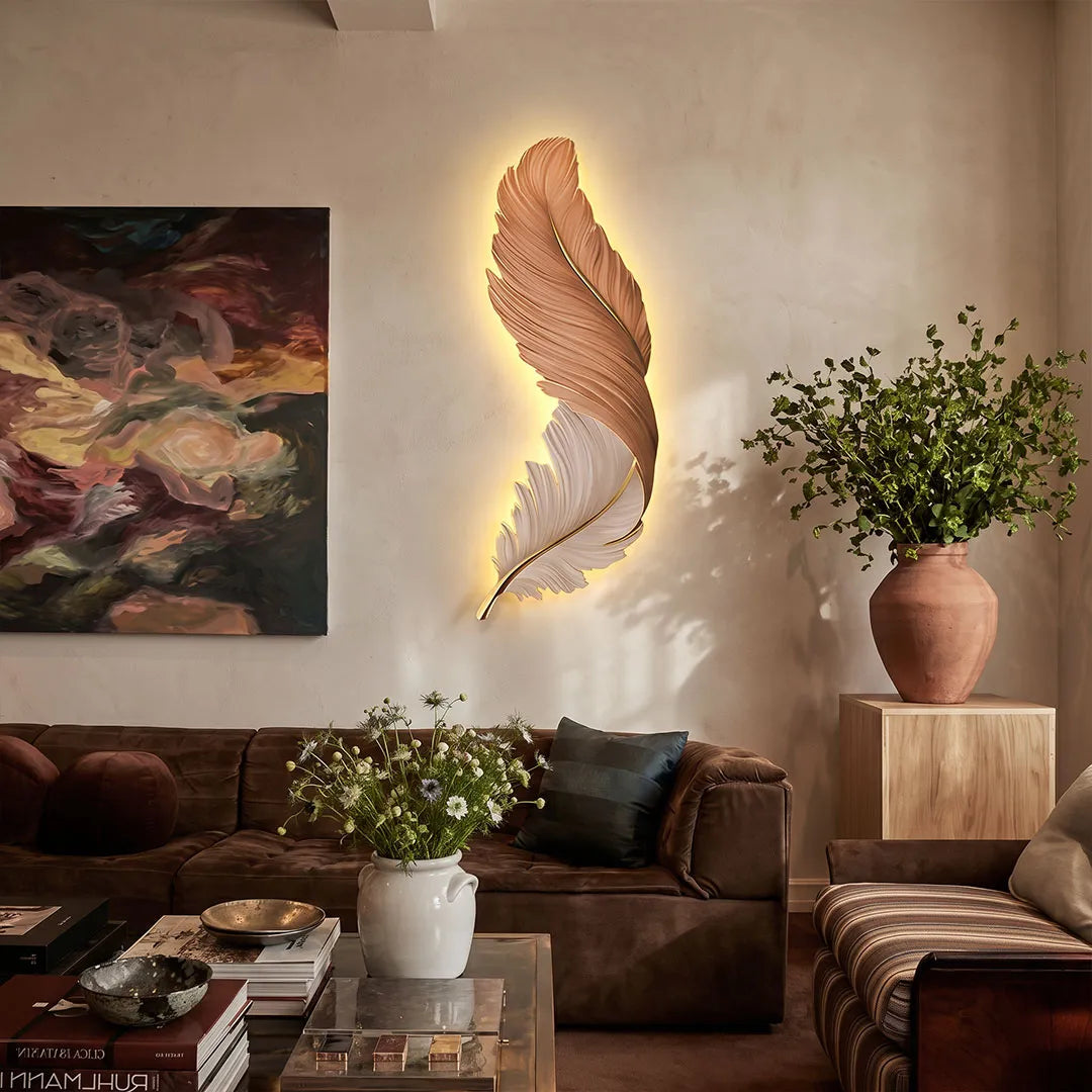 Feather wall lamp above a brown leather sofa, featuring a sculptural feather shape with warm ambient backlighting.