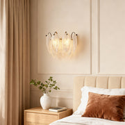 Modern luxury chandeliers inspired feather wall light above bed with neutral tones and soft textiles