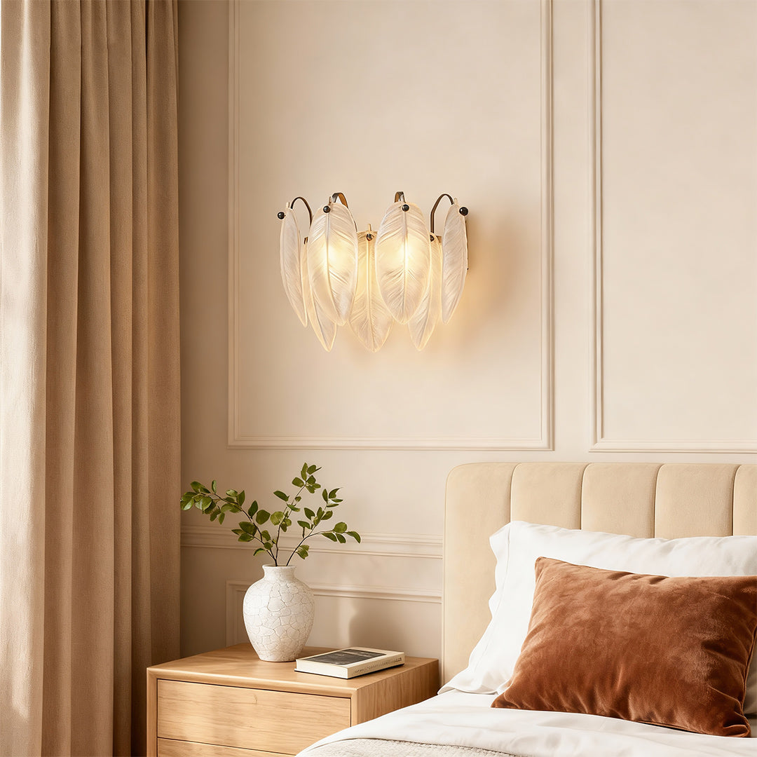 Modern luxury chandeliers inspired feather wall light above bed with neutral tones and soft textiles