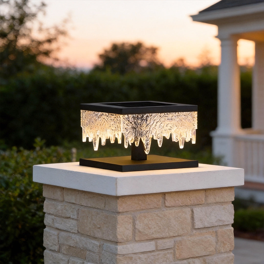 Fence pillar lights illuminating a modern garden pathway with warm, ambient glow.