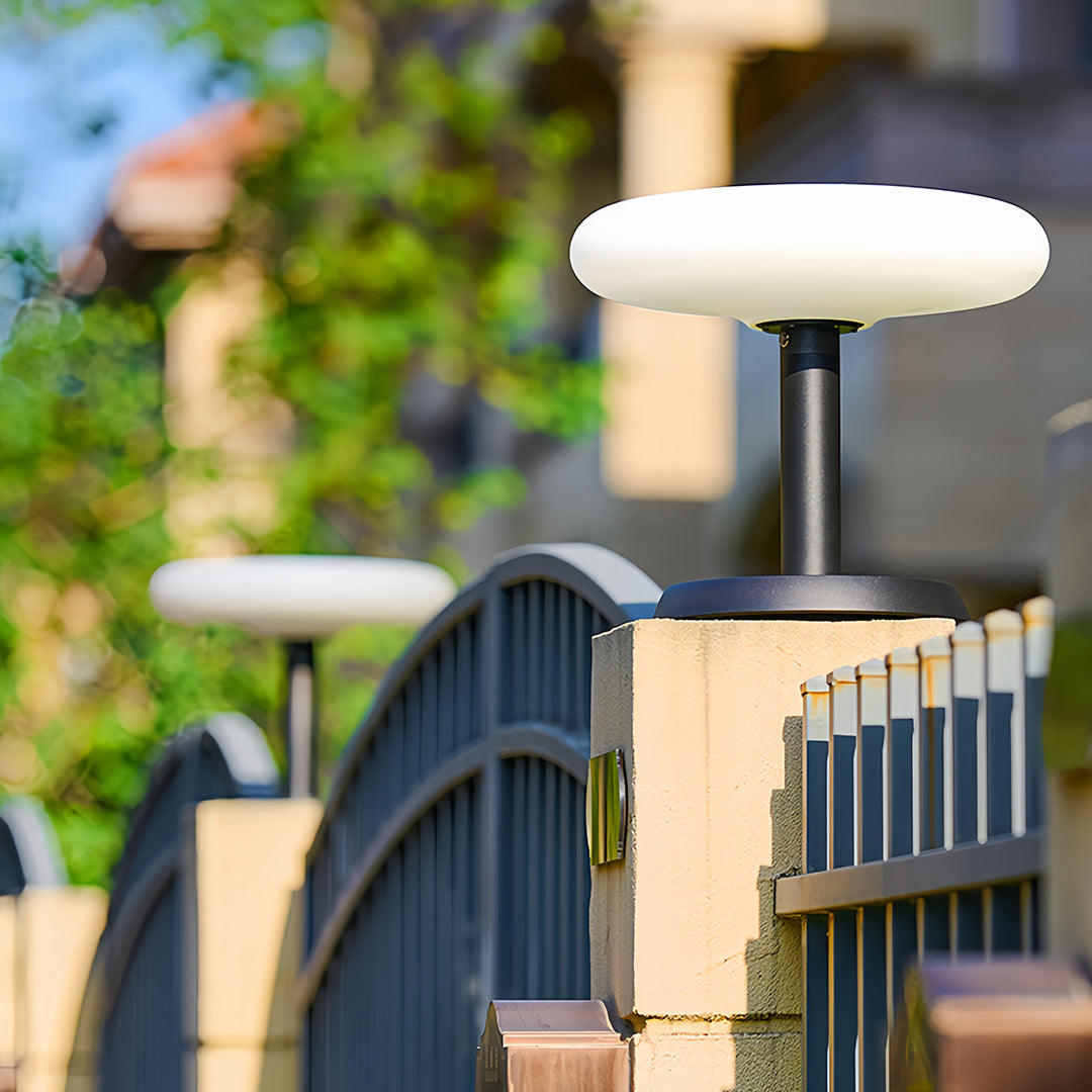 Solar LED post light near a fence, stylish and functional outdoor lighting for pathways