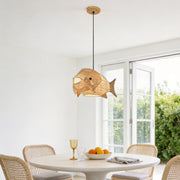 Fish pendant light with a woven design, hanging above a modern dining table.