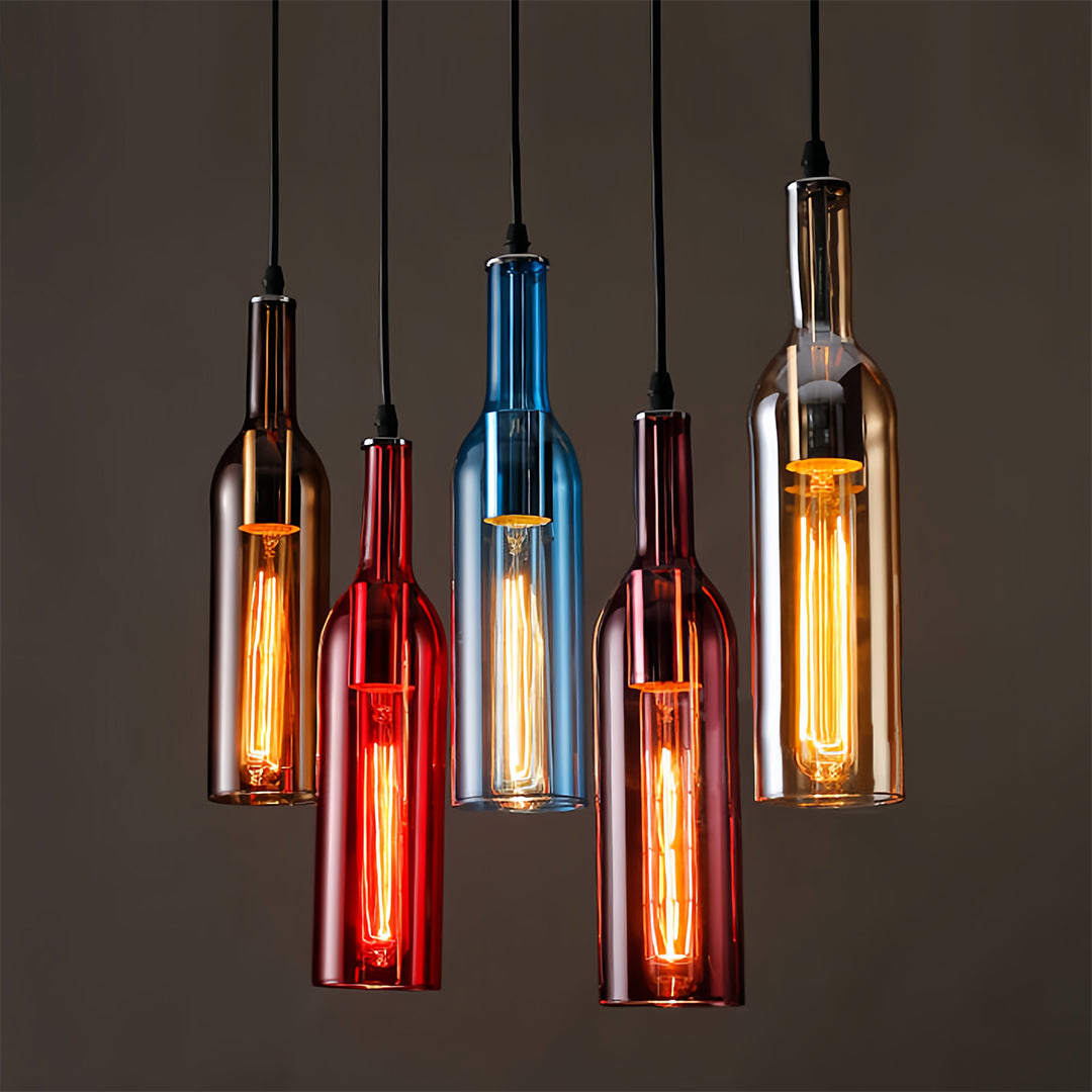 Five wine bottle pendant lights in warm tones creating clustered lighting installation against dark setting