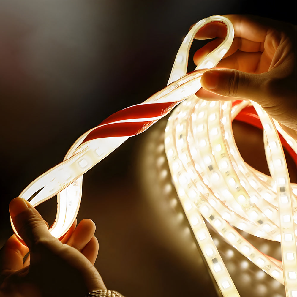 Flexible battery powered LED light strip being handled showing bendable design and warm glow