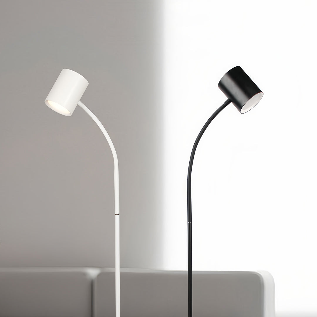 Flexible tall floor lamps positioned in modern bedroom creating focused reading light