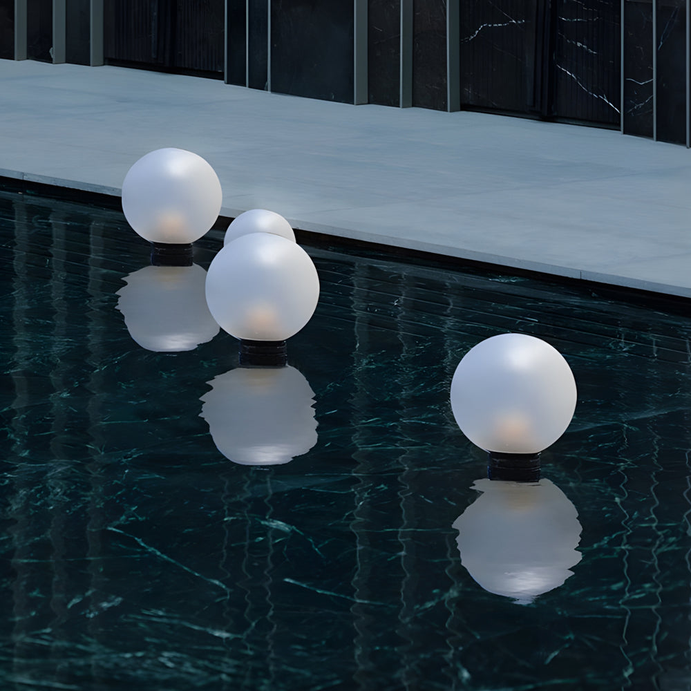 Silver Metal Table Lamp floating round globe lights creating stunning reflective illumination on water surface with modern spherical design