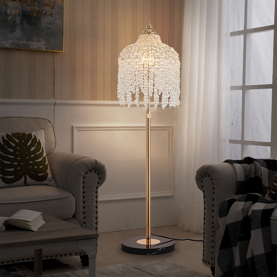 Elegant gold teardrop floor crystal lamps adding sparkle to a modern living space with neutral decor.
