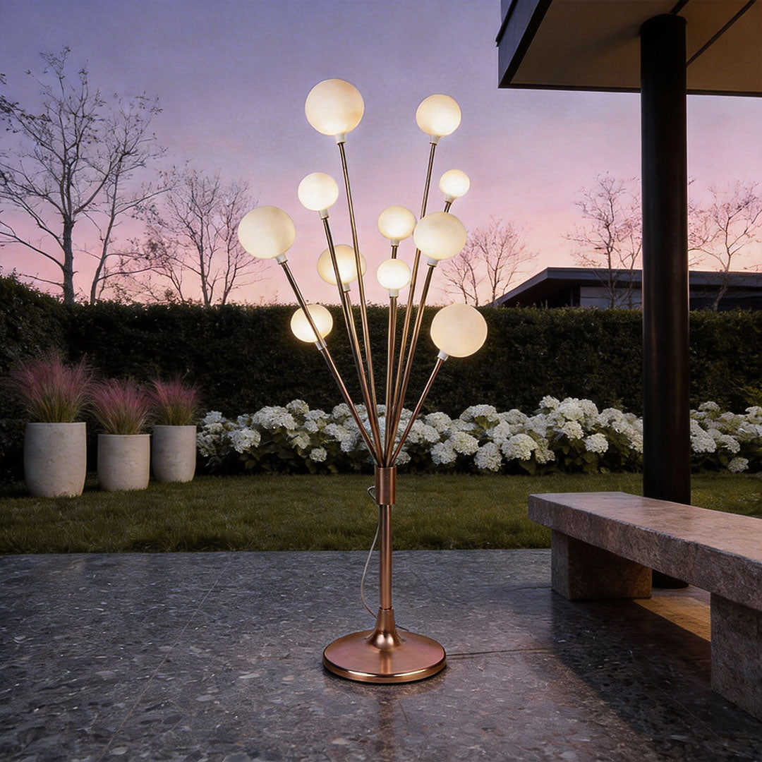 Floor lamp decor with a modern tree design, featuring multiple spherical lights in a garden setting.