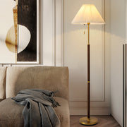Floor wood lamp illuminating cozy living room with warm ambient lighting and comfortable seating