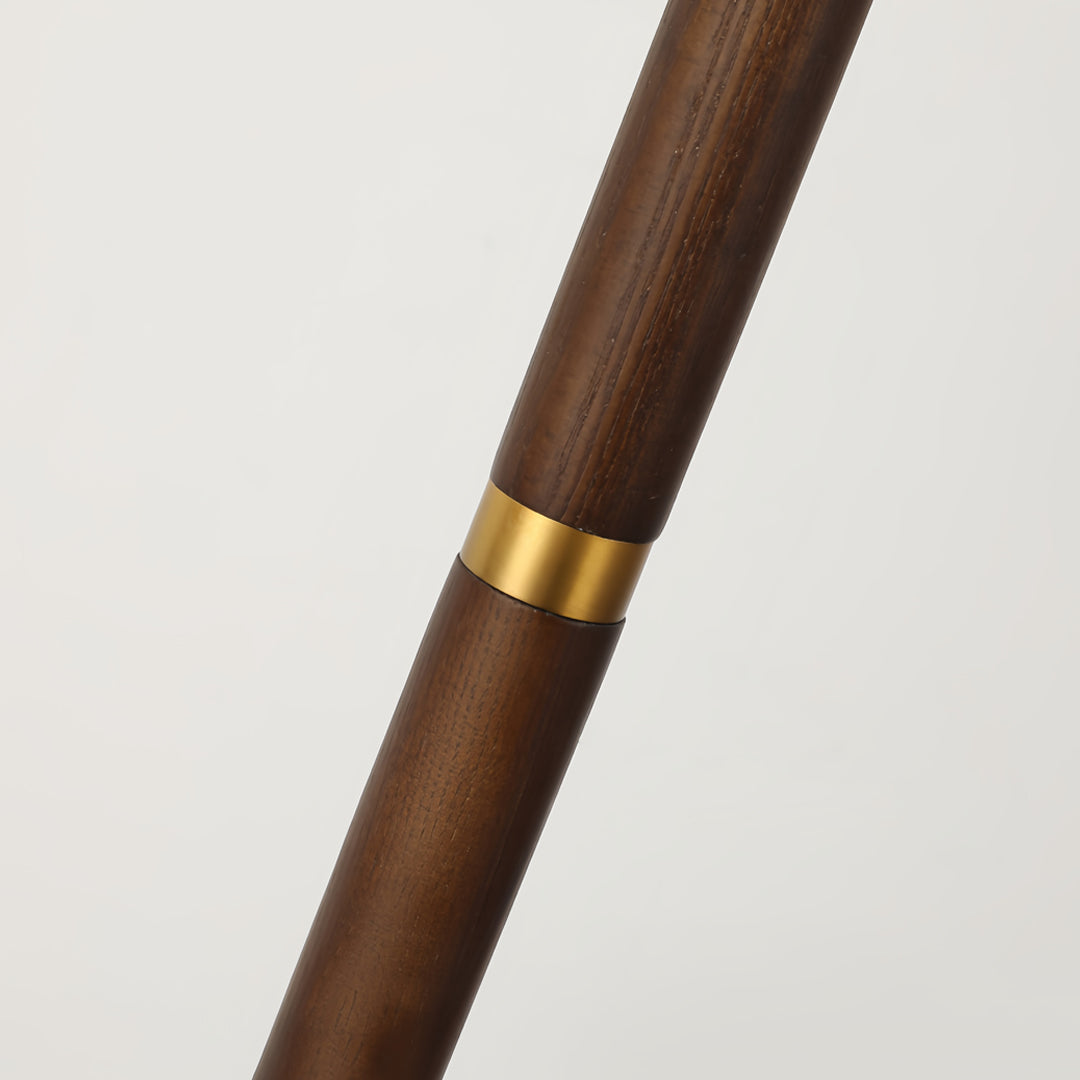 Floor wood lamp pole detail showcasing natural wood grain and brass accent ring construction
