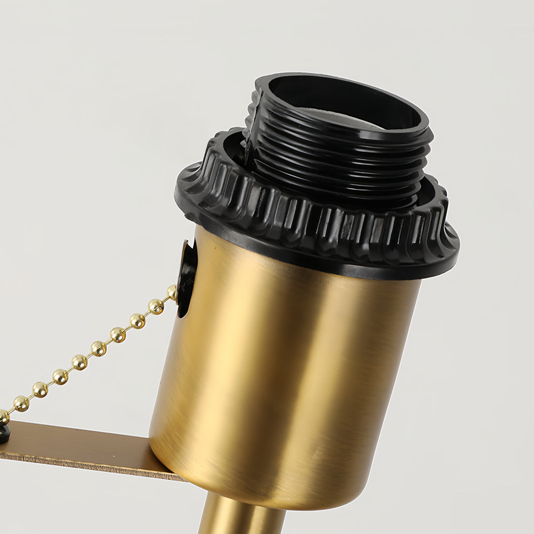 Floor wood lamp switch detail displaying brass pull chain mechanism and premium hardware finish