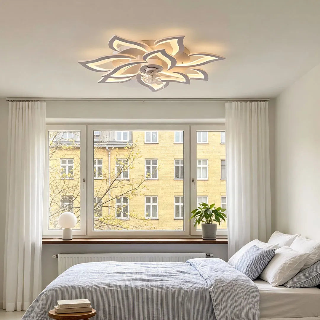 Decorative ceiling fans with lights installed in a bright bedroom with elegant floral-shaped blades and soft illumination.