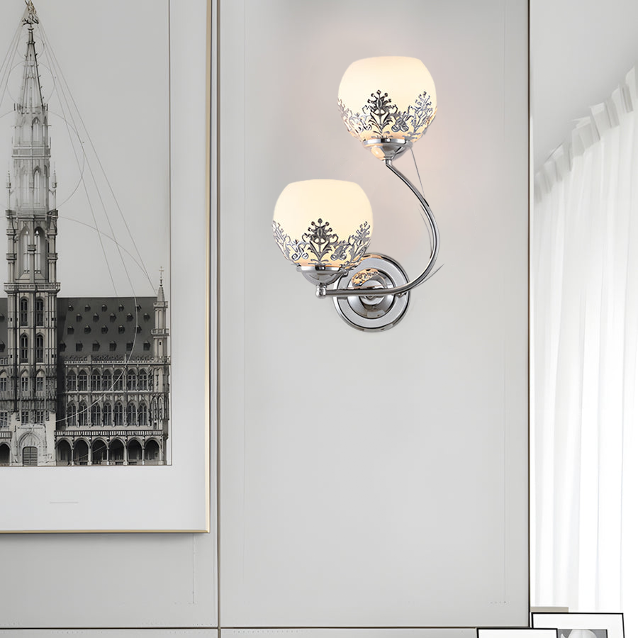 Floral wall sconce placed beside framed artwork in a refined interior setting.