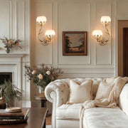 Floral wall sconces installed in a classic living room with elegant panelled walls.