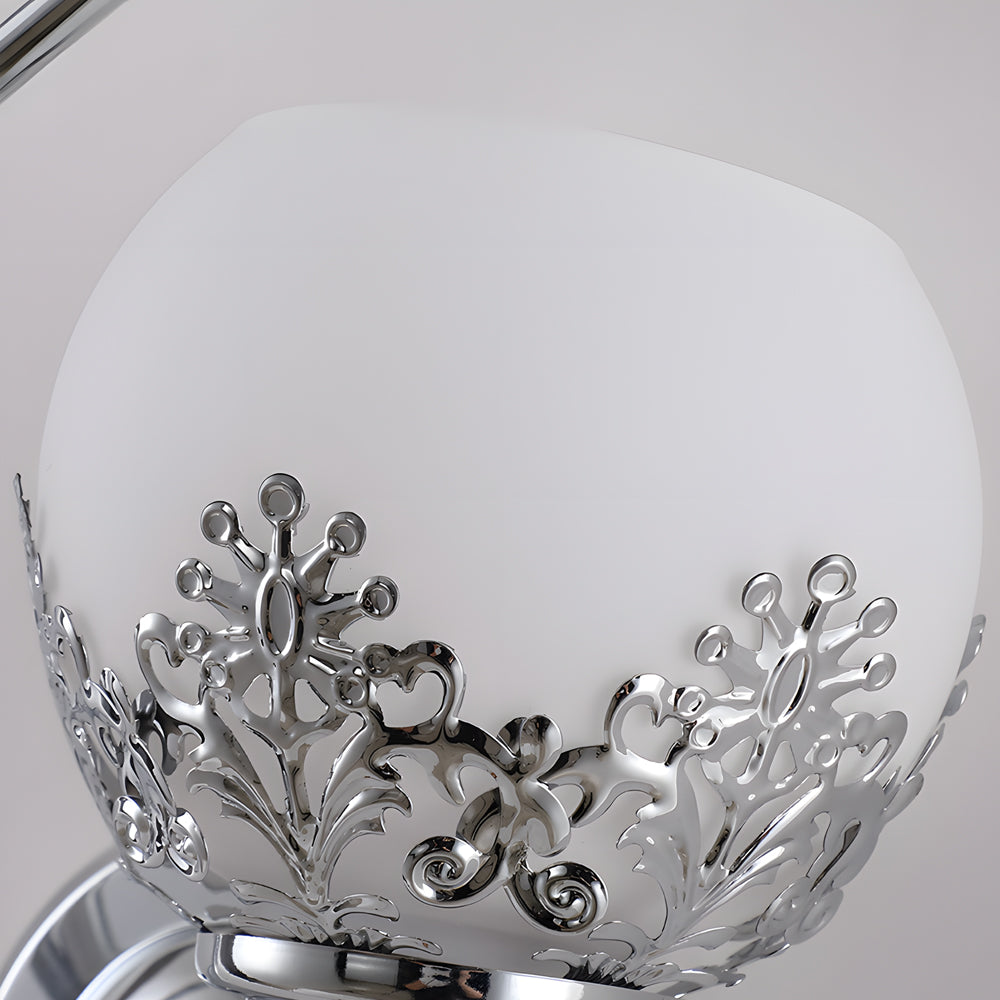 Close-up of floral wall sconce glass shade with etched floral pattern.