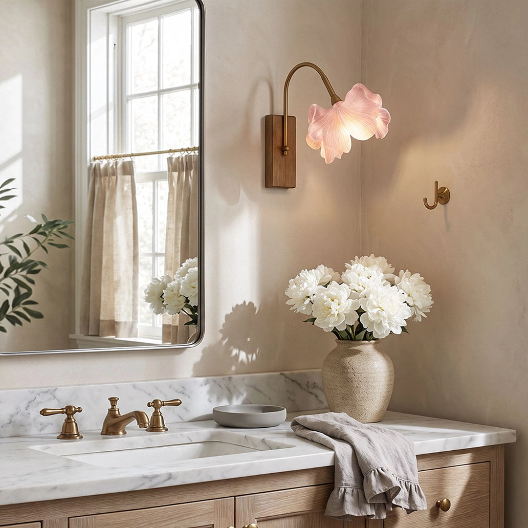 Flower wall light above a bathroom vanity with a soft pink floral shade and warm ambient glow.