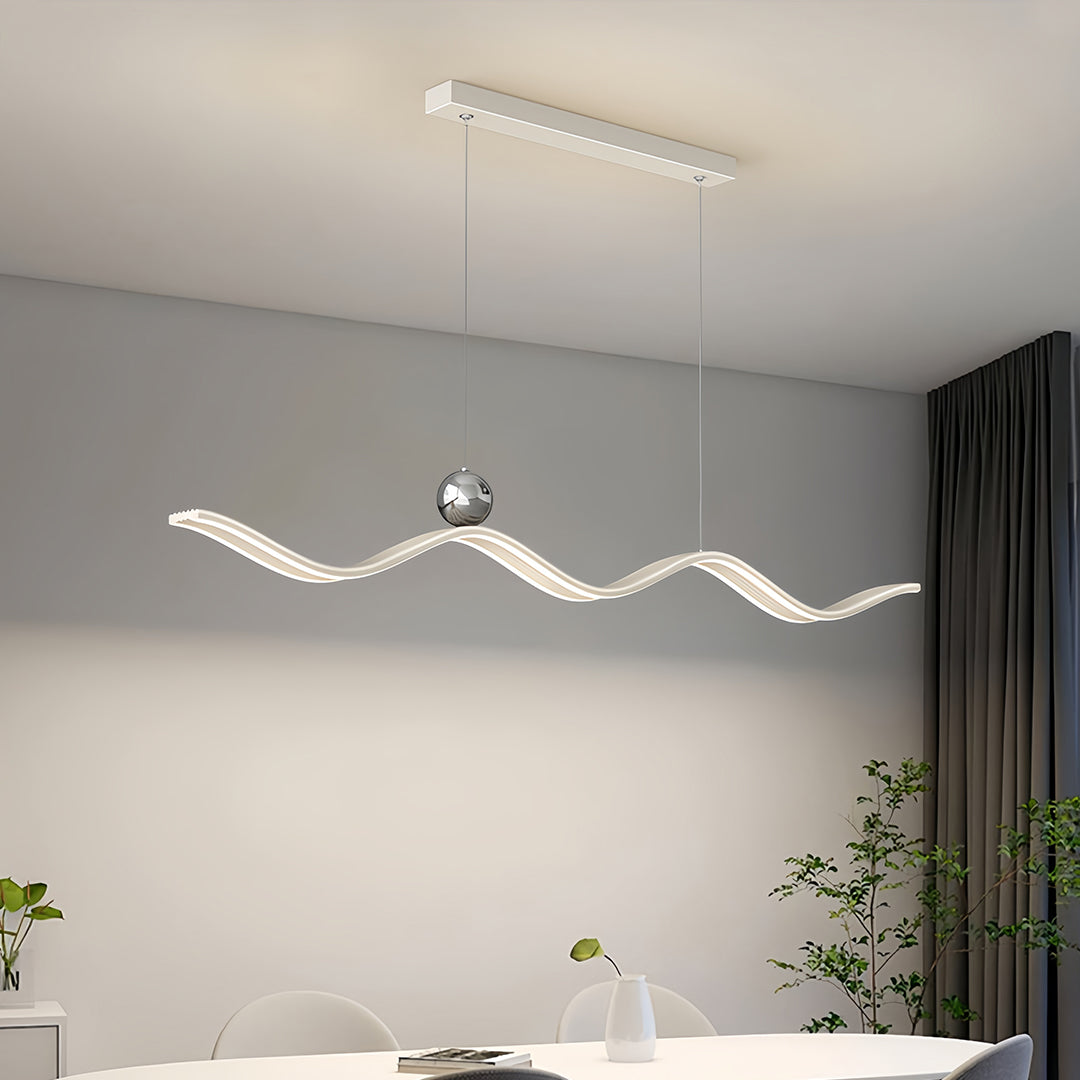 Modern wave chandelier hanging above a white table, showcasing the unique, fluid design lines.