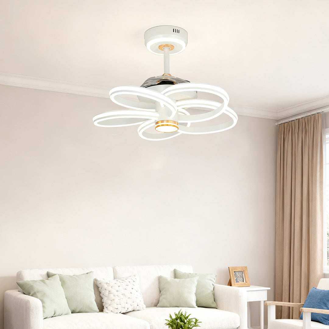Flush mount ceiling fans white with light providing soft illumination in a charming girl's bedroom with tassels and bohemian decor. 